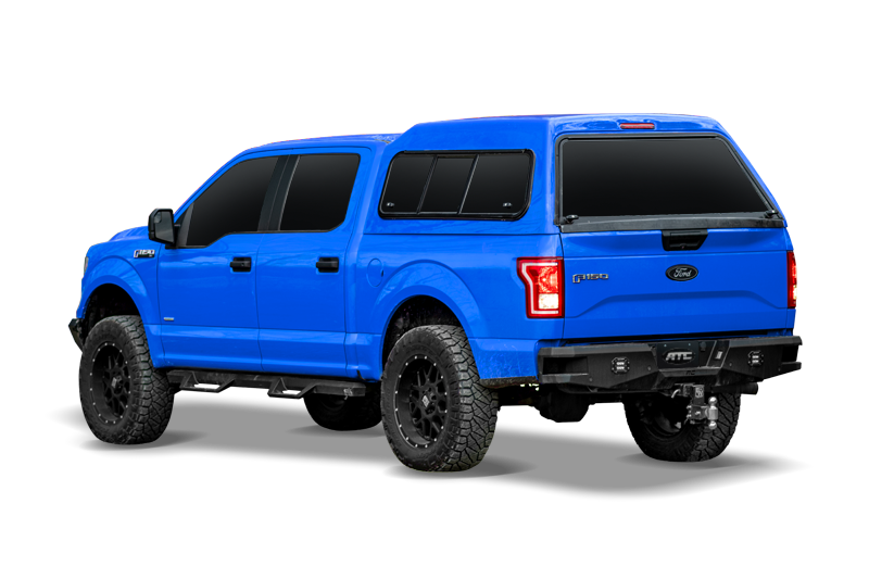 blue ford f150 with a mid-rise truck cap